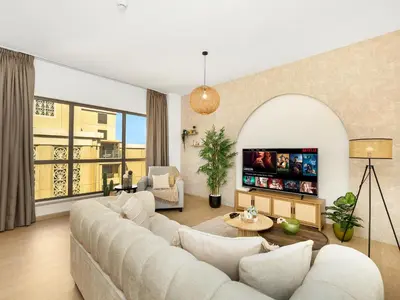 a living room with a couch and a table at Beachfront 2BR Dubai Eye & Sea View Beach Access in Dubai