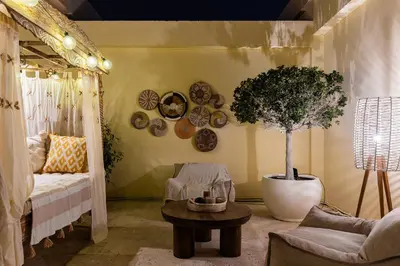 a living room with a couch and a potted tree at Penthouse four bedroom with two large chillout terraces in Dubai