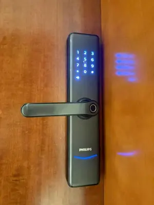 a remote control sticking out of a wooden door at Spacious Apartment with Excellent Facilities in Dubai