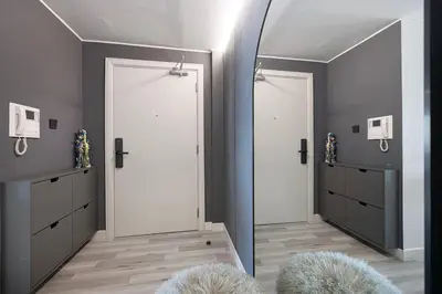 a mirror in a room with two white doors at Spacious Apartment with Excellent Facilities in Dubai