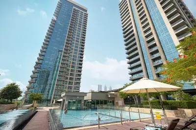 a swimming pool in front of two tall buildings at Spacious Apartment with Excellent Facilities in Dubai