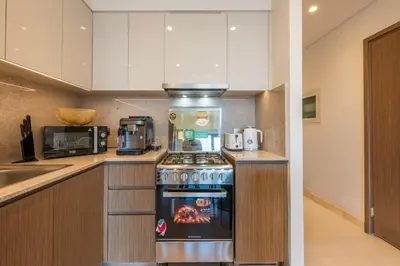 a kitchen with a stove and a microwave at Stunning Burj Khalifa View! Steps to Dubai Mall in Dubai