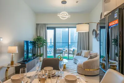 a living room with a couch and a table at Stunning Burj Khalifa View! Steps to Dubai Mall in Dubai