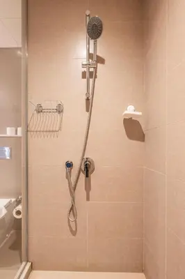 a shower with a shower head in a bathroom at Stunning Burj Khalifa View! Steps to Dubai Mall in Dubai