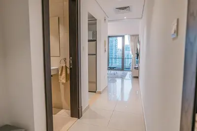 a hallway with a view of a kitchen and a living room at Dubai Marina Skyline with Sunset and Sunrise View in Dubai