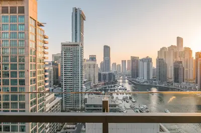 a view of a city skyline with buildings at Dubai Marina Skyline with Sunset and Sunrise View in Dubai