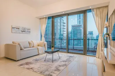 a living room with a couch and a large window at Dubai Marina Skyline with Sunset and Sunrise View in Dubai