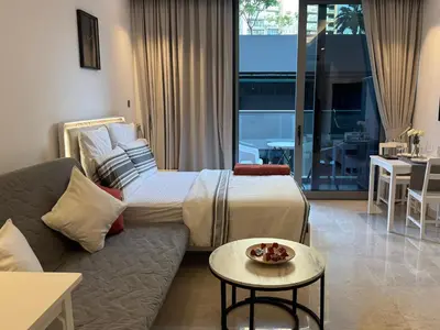 a hotel room with a bed and a couch at The Sterling 4 sleep with AC parking and pool in Dubai