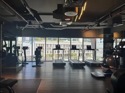 a gym with treadmills and machines in a room at The Sterling 4 sleep with AC parking and pool in Dubai
