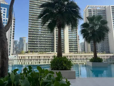 a view of a city with palm trees and buildings at The Sterling 4 sleep with AC parking and pool in Dubai