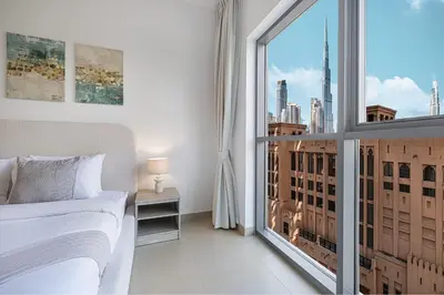 a bedroom with a bed and a large window at Sanctuary Stays - Premium 1BR - Burj Khalifa Views - Near Dubai Mall in Dubai
