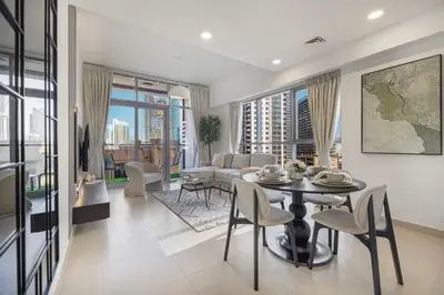 a living room with a table and chairs and a couch at Sanctuary Stays - Premium 1BR - Burj Khalifa Views - Near Dubai Mall in Dubai