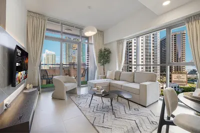 a living room with a couch and a large window at Sanctuary Stays - Premium 1BR - Burj Khalifa Views - Near Dubai Mall in Dubai