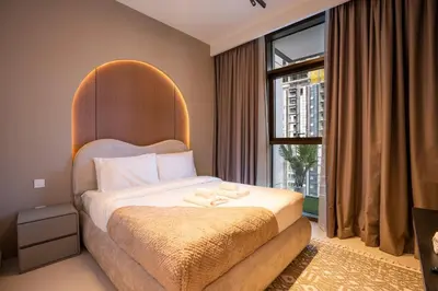 a bedroom with a bed with a large window at Luxury 2BR at Burj Crown Sleeps 7 PS5 & 65-inch TV in Dubai