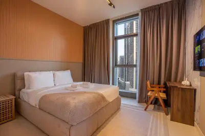 a hotel room with a bed and a large window at Luxury 2BR at Burj Crown Sleeps 7 PS5 & 65-inch TV in Dubai