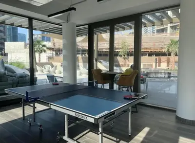 a ping pong table in the middle of a room at Medina Studio Burj Khalifa View in Dubai
