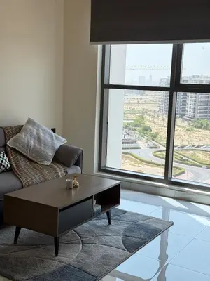 a living room with a couch and a coffee table at Peaceful Cozy 1 BHK Pool Garden View Liwan Dubai Land in Dubai