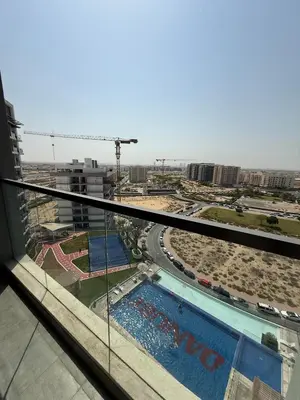 a view of a swimming pool from a building at Peaceful Cozy 1 BHK Pool Garden View Liwan Dubai Land in Dubai