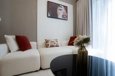 a living room with a white couch and a vase at Designer 1BR Apt with Modern and Airy Layout in Dubai