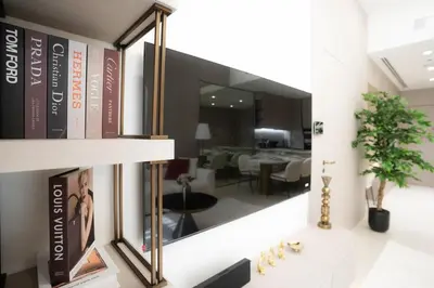 a large mirror on a wall in a living room at Designer 1BR Apt with Modern and Airy Layout in Dubai