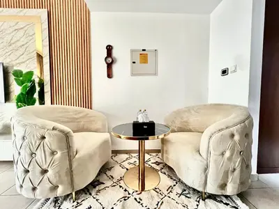 two chairs and a table in a living room at Spacious Modern Studio In downtown in Dubai