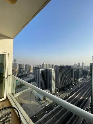 a view of a city from the balcony of a building at Spacious Modern Studio In downtown in Dubai