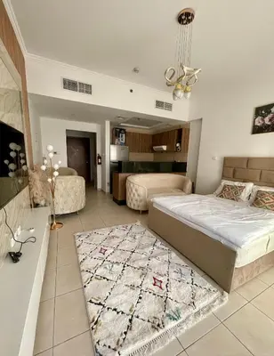 a large bedroom with a bed and a rug at Spacious Modern Studio In downtown in Dubai