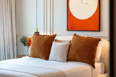 a bed with brown pillows in a room at Luxury Renovated 1BR w Full Sea View in Dubai