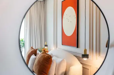 a mirror reflection of a couch in a room at Luxury Renovated 1BR w Full Sea View in Dubai