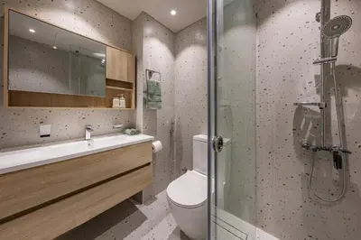 a bathroom with a toilet and a glass shower at harborfront elegance dubai in Dubai