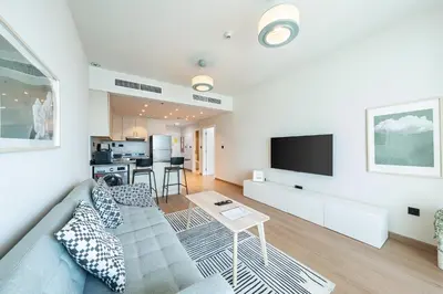 a living room with a couch and a tv at harborfront elegance dubai in Dubai