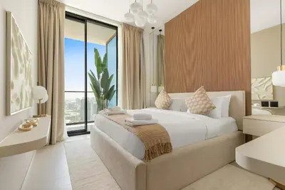 a bedroom with a large bed and a large window at VayK - Modern 2BD Retreat with Private Pool in JVC in Dubai