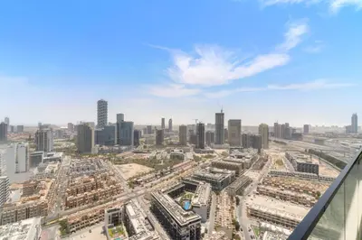 an aerial view of a city with tall buildings at VayK - Modern 2BD Retreat with Private Pool in JVC in Dubai