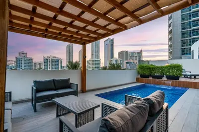 a rooftop patio with a pool and a table and chairs at Private villa in Marina with private pool!!! in Dubai