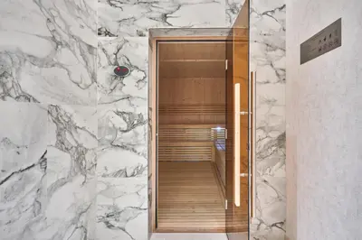 a bathroom with a marble wall and a walkway at STAY BY LATINEM Luxury 1BR Holiday Home CB 3107 Near Burj Khalifa in Dubai