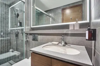 a bathroom with a sink and a shower at STAY BY LATINEM Luxury 1BR Holiday Home CB 3107 Near Burj Khalifa in Dubai