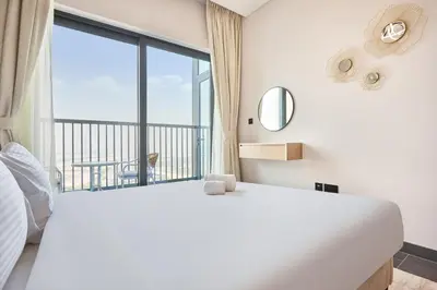 a bedroom with a white bed and a large window at STAY BY LATINEM Luxury 1BR Holiday Home CB 3107 Near Burj Khalifa in Dubai