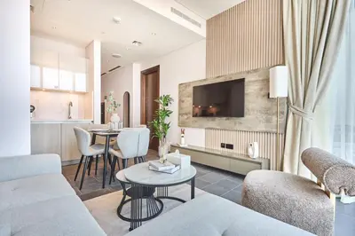 a living room with a couch and a table at STAY BY LATINEM Luxury 1BR Holiday Home CB 3107 Near Burj Khalifa in Dubai