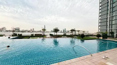 a large swimming pool on top of a building at Luxury 2BR 34th Floor Burj Khalifa Sea Creek View in Dubai