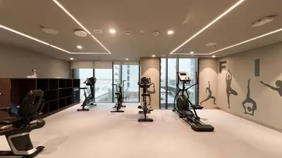 a gym with treadmills and elliptical machines at Luxury 2BR 34th Floor Burj Khalifa Sea Creek View in Dubai