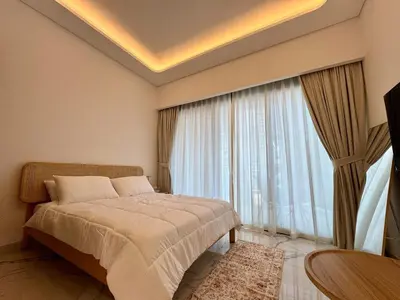 a bedroom with a bed and a large window at Stylish Studio In Azizi Riviera 59 in Dubai