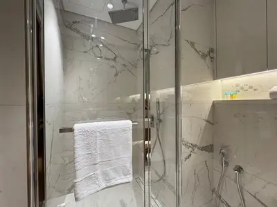 a bathroom with a shower with a glass door at Stylish Studio In Azizi Riviera 59 in Dubai