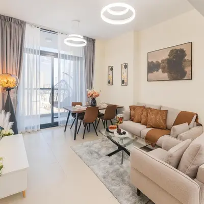 a living room with a couch and a table at Work & Relax Above the City- JVC Perfect Stay in Dubai