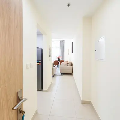 a hallway with white walls and a white floor at Work & Relax Above the City- JVC Perfect Stay in Dubai