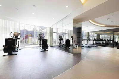 a gym with treadmills and ellipticals in a building at Stunning Studio facing Burj Khalifa in Dubai
