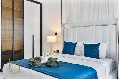a bedroom with a large bed with blue and white at Bookable Stylish Dubai escape with private pool in Dubai