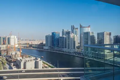 a view of a city with a river and buildings at Cozy Waterfront Studio Pool, Gym, Parking in Dubai