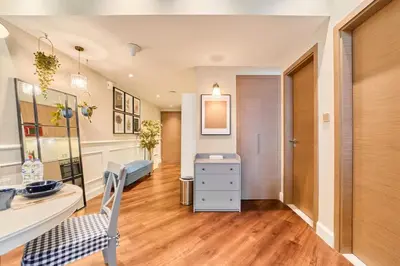 a room with a desk and a chair in it at FAM Living Contemporary 1BR Apartment Urban Oasis in Dubai