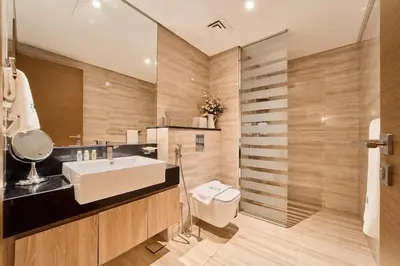 a bathroom with a sink and a toilet and a shower at FAM Living Contemporary 1BR Apartment Urban Oasis in Dubai