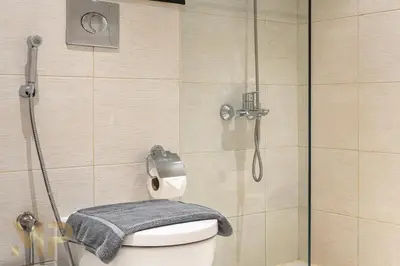 a bathroom with a shower and a toilet with a towel at Marcopolo - Experience modern living in Business Bay Dubai in Dubai